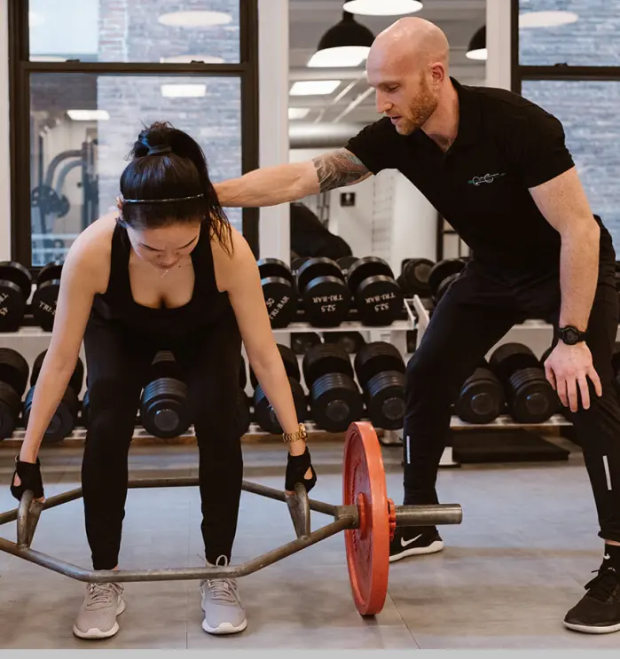 Client performing deadlift training with Zach Moore coaching